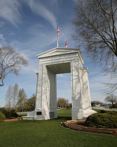 The white Peace Arch with the US and Canadian flags on top
